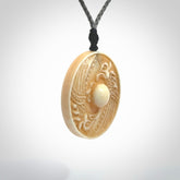 This piece is a hand carved contemporary bone shield pendant. Yuri Terenyi has carved this from Bone. It is a delightful, artistic piece of jewellery. One only necklace.